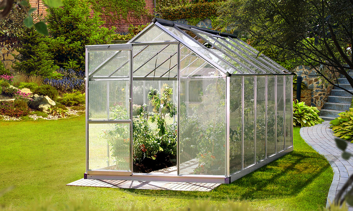 Greenfingers_Brands A Greenfingers greenhouse filled with lush plants.